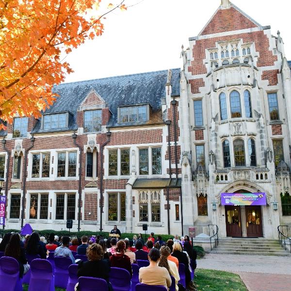 Buttrick Hall behind a ceremony. 